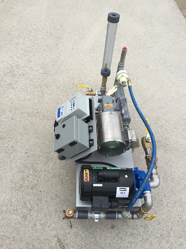 A side view of Clearwater's LQ50 liquid polymer dosing system on a concrete pad.