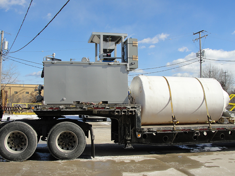 Clearwater Industries Model 500 Stainless Steel Big Bag polymer make-down system pictured from the side while on a semi-truck bed before it leaves for delivery.