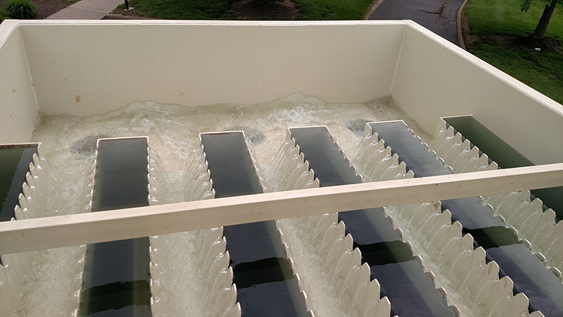 Pretreated water running over weirs and into a clean water tank before it's treated to become high purity water.