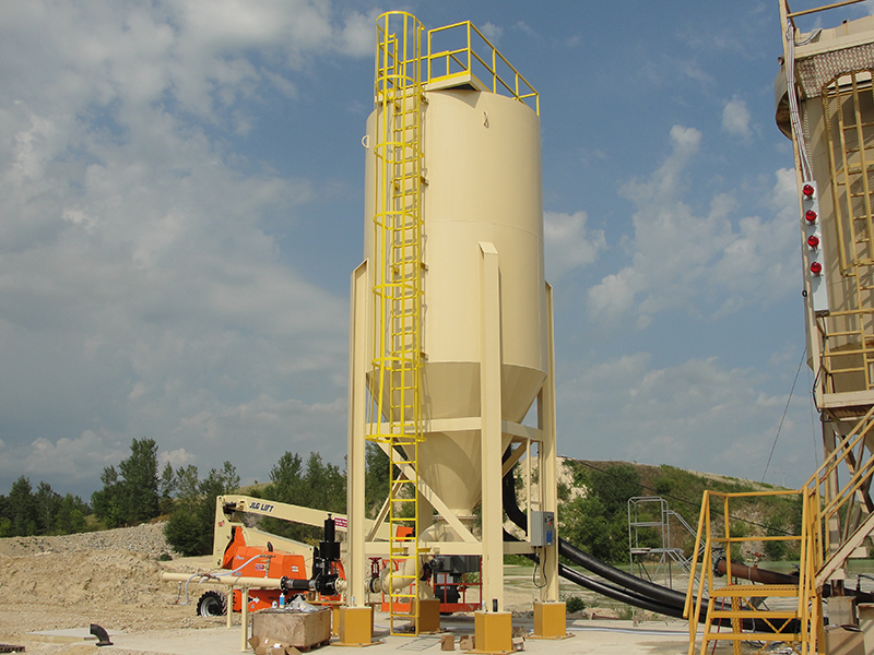 A tan industrial high compaction water clarifier setup at an aggregate production site.