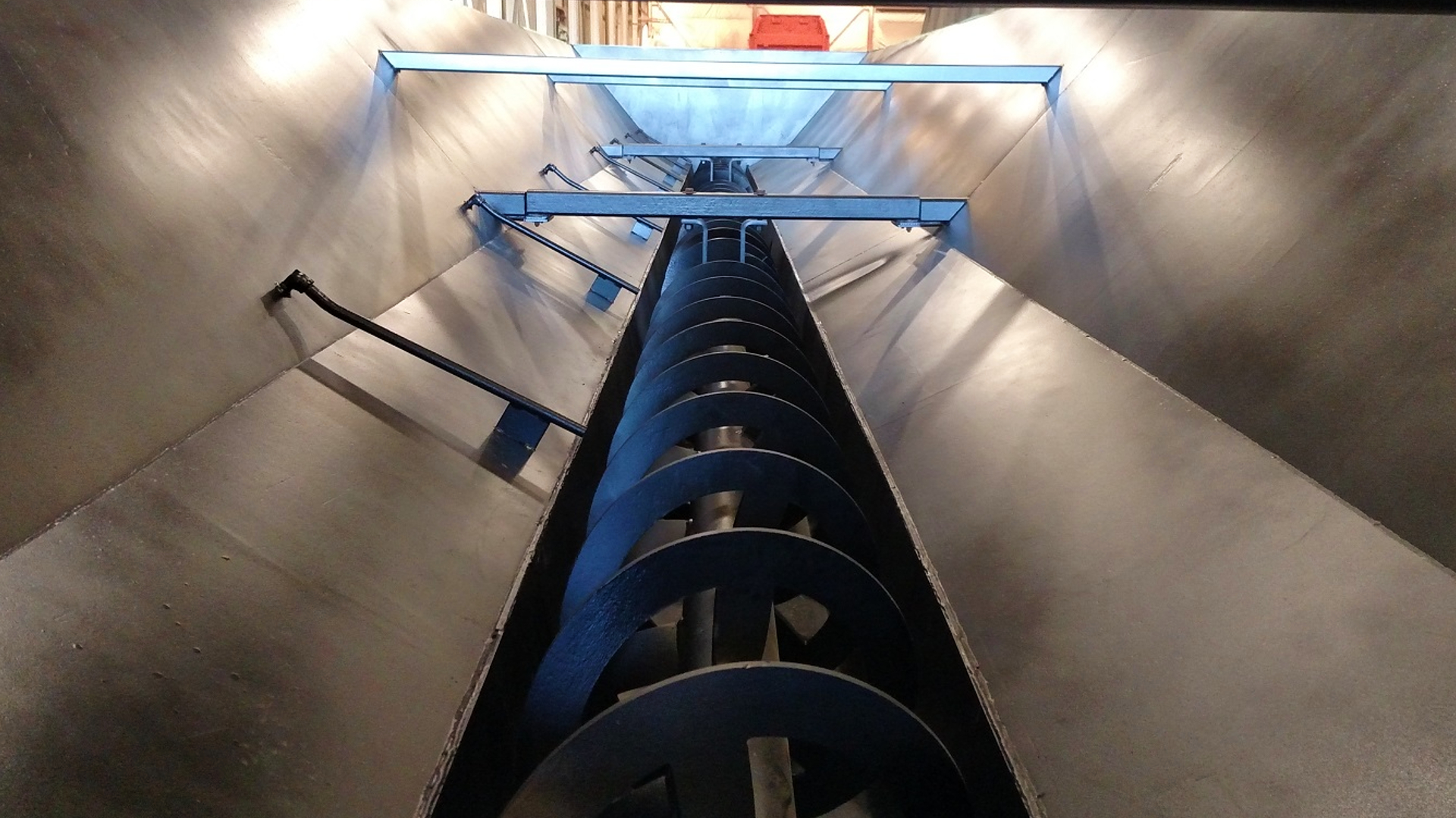 The inside of a horizontal flow clarifier with an auger.