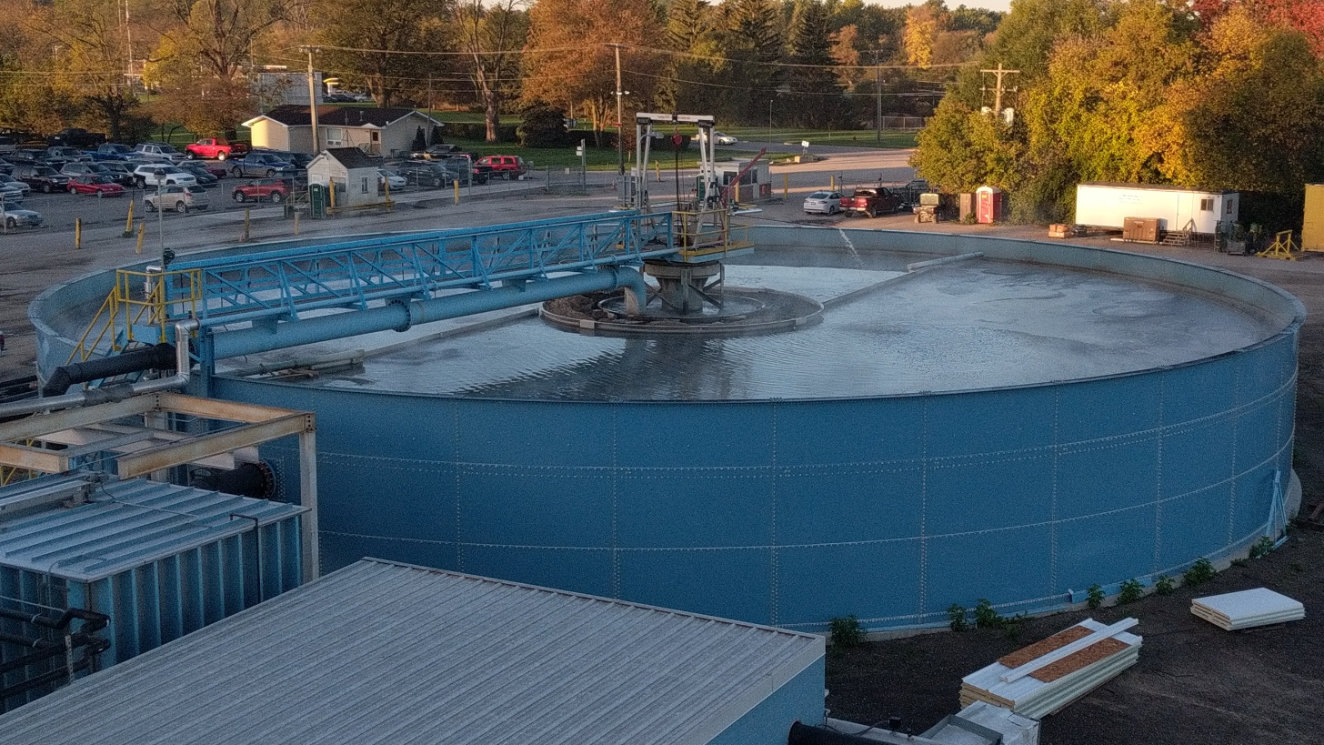 A circular clarifier with steam rising off the water.