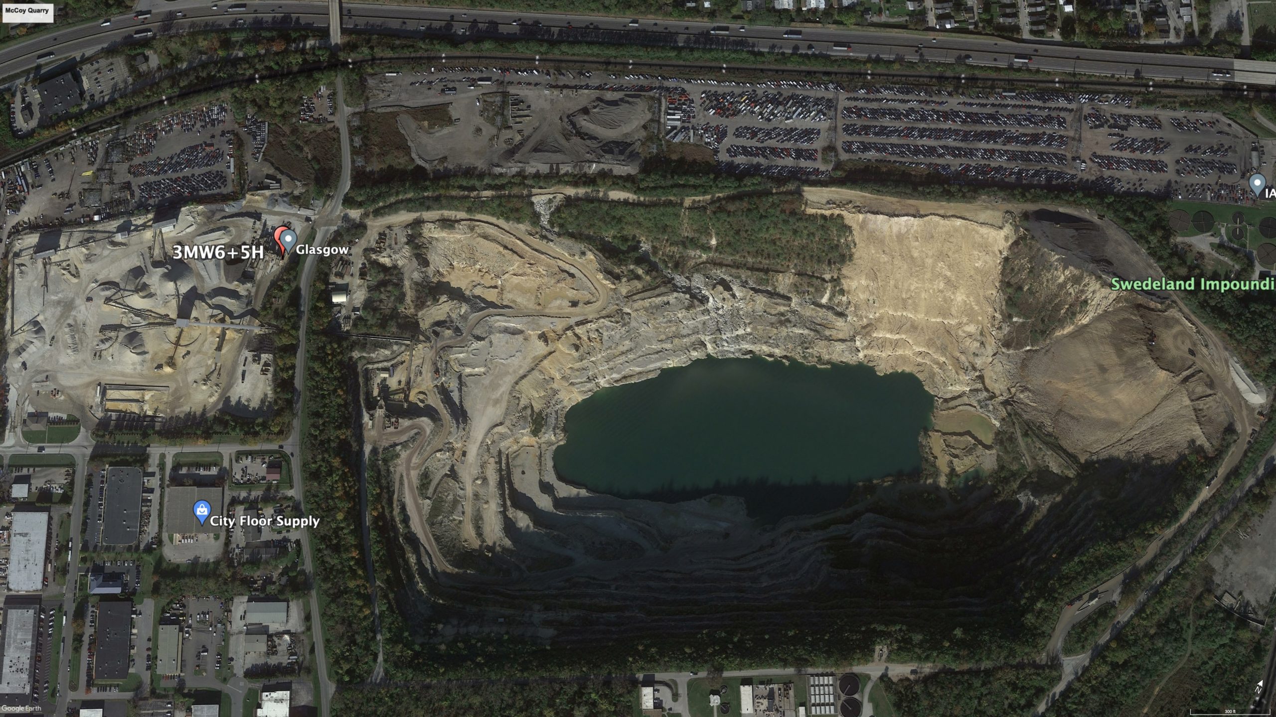 A Google Earth image of a quarry surrounded by an urban area.