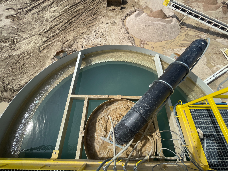 The top of a clarifier with dirty water entering a center tank and clean water in the peripheral tank.