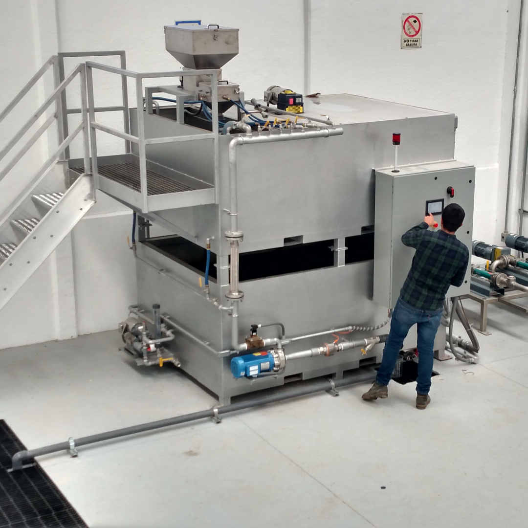 A man programming a dry chemical preparation system indoors.