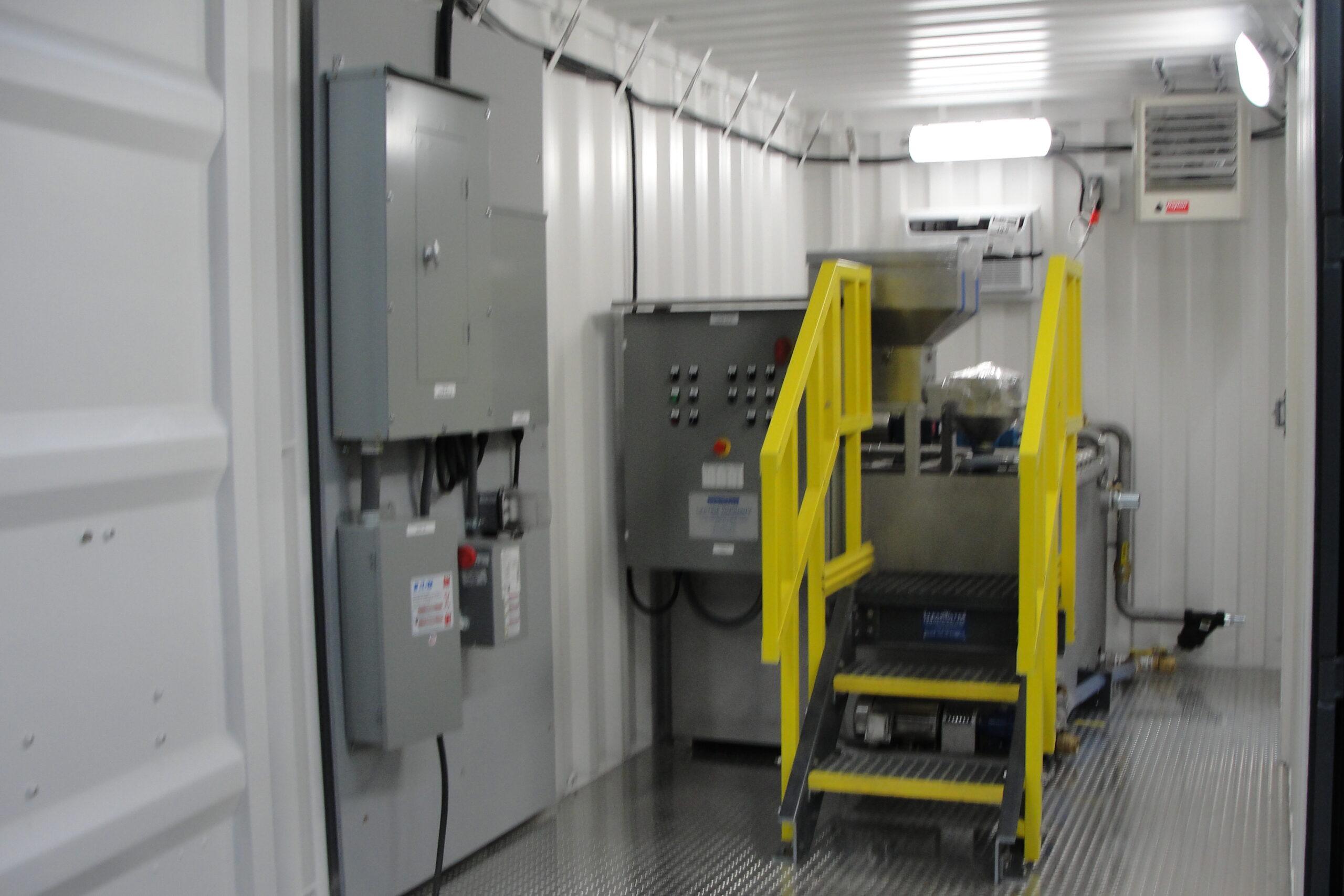 Poly System_Installed A dry polymer system made out of 304SS inside a 15 ft shipping container with LED lighting, electrical distribution board, and diamond plated floors.