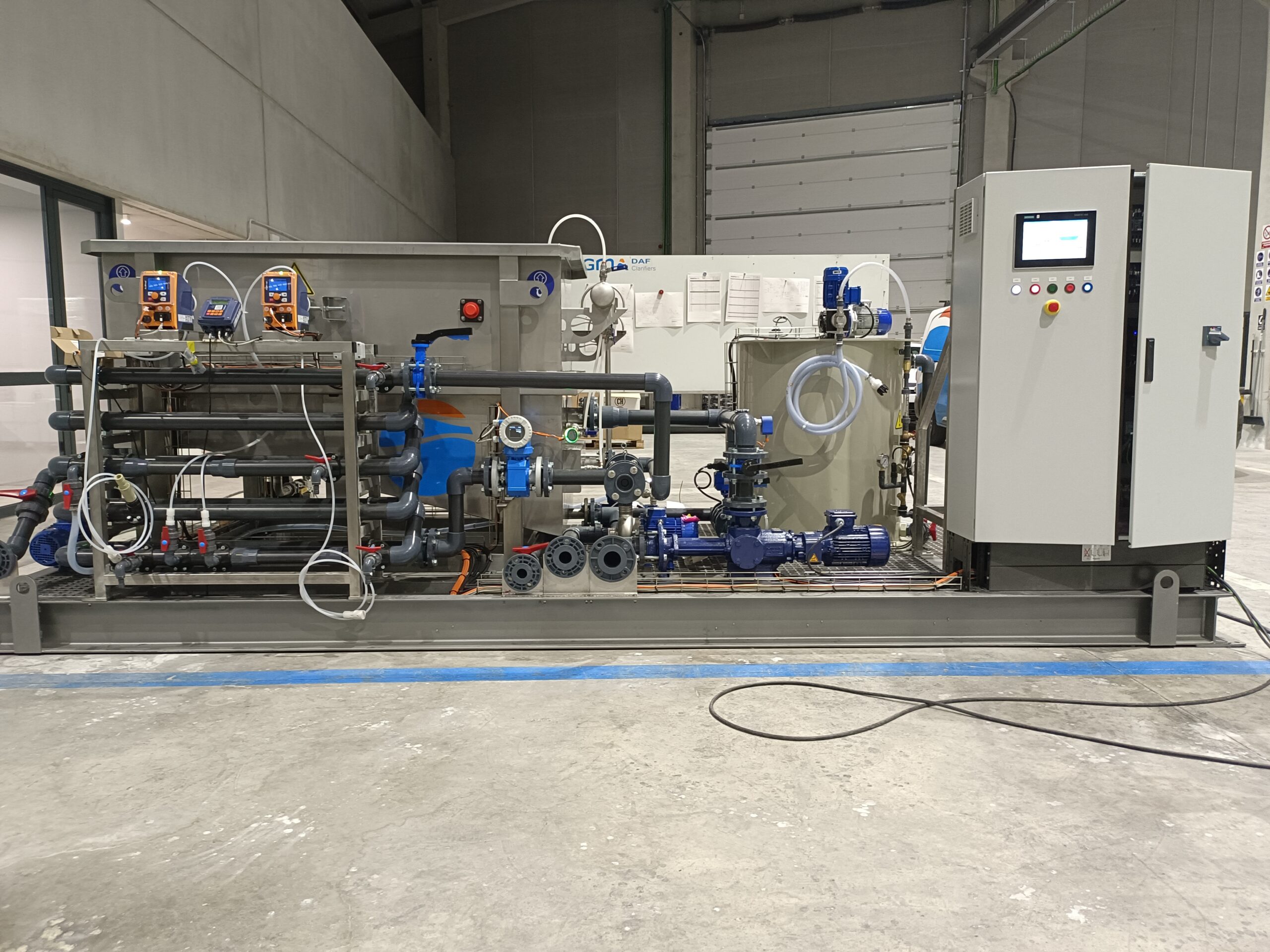 A variety of industrial equipment mounted on a single skid. The equipment includes serpentine pvc pipes, a chemical tank, a stainless steel DAF tank, and a control panel to create a compact DAF system.